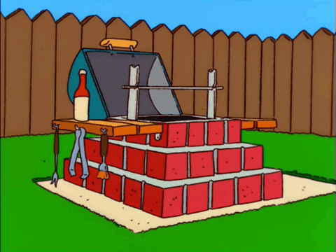 A gif of Homer Simpson attempting to build a bbq, holding up the perfect picture of the BBQ over the one he built, slowly removing it to find his version is just a pile of poorly constructed pieces, stuck in cement.